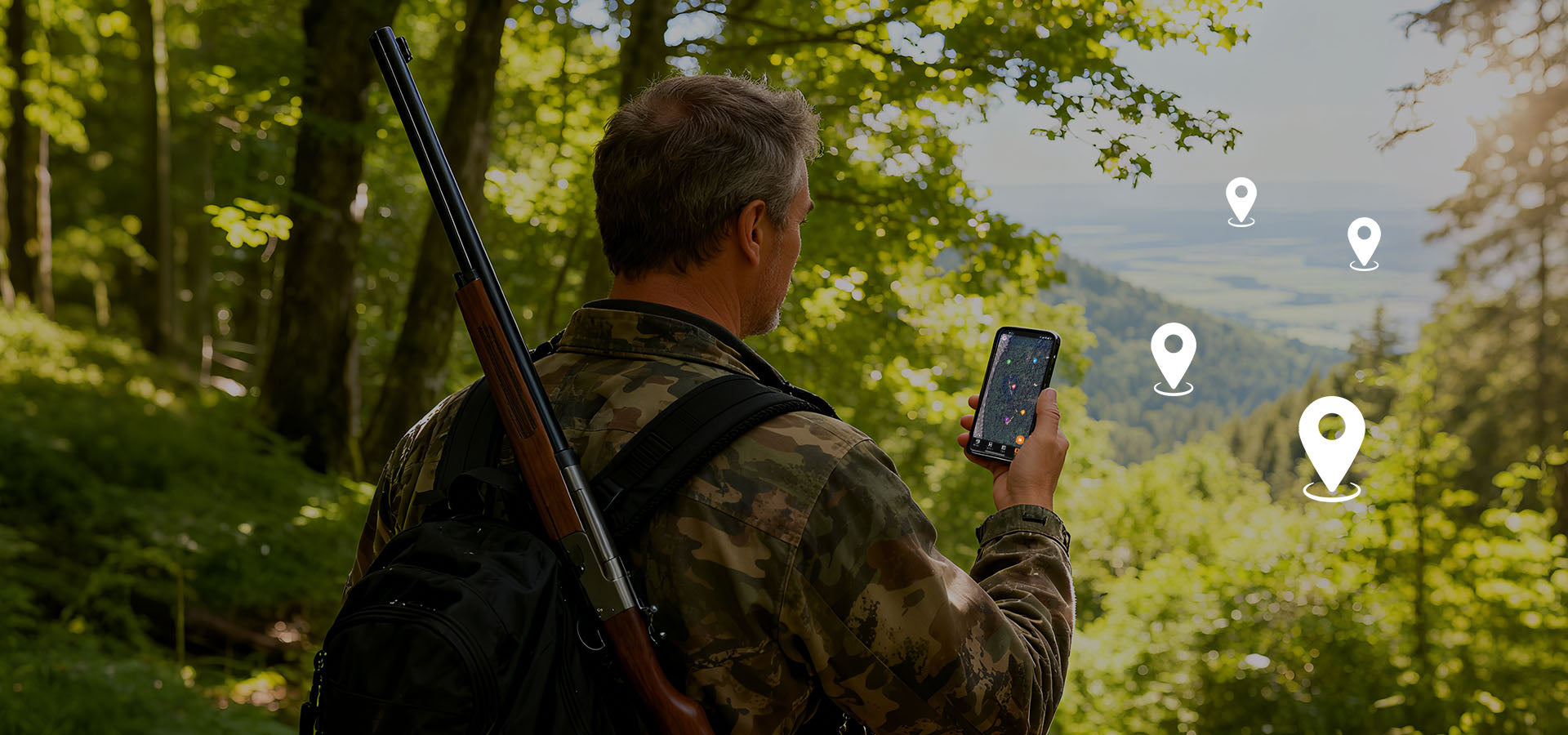 Hunter using a smartphone to locate GardePro E6+ WiFi trail cameras via GPS map tracking in a forest